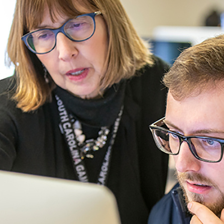 Two people looking at computer