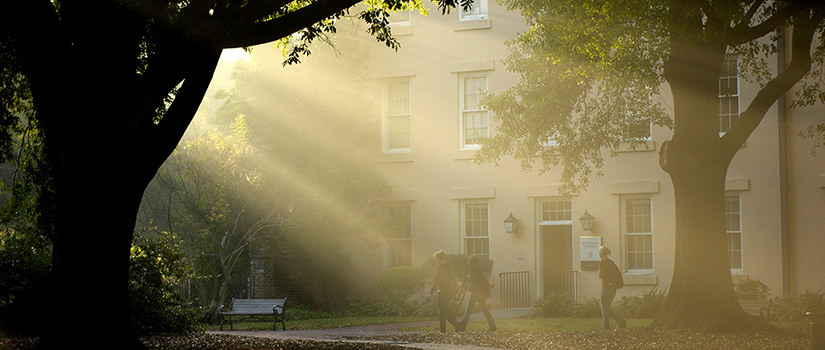 Students walking in sunlight through the USC horseshoe