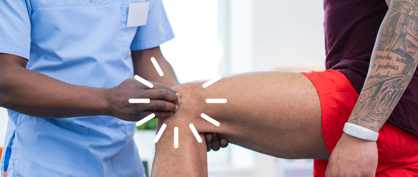 Health care provider examines a patient's knee.