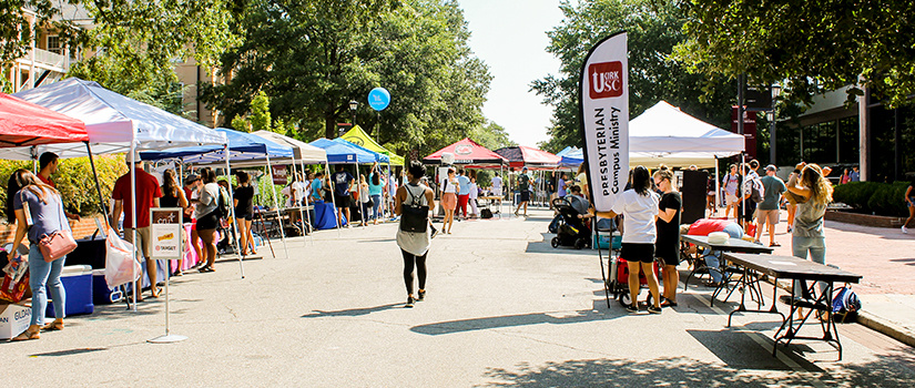 Students gather at a spiritual life fair on Greene Street