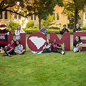 Students and cocky posing in front of letters spelling HOME.