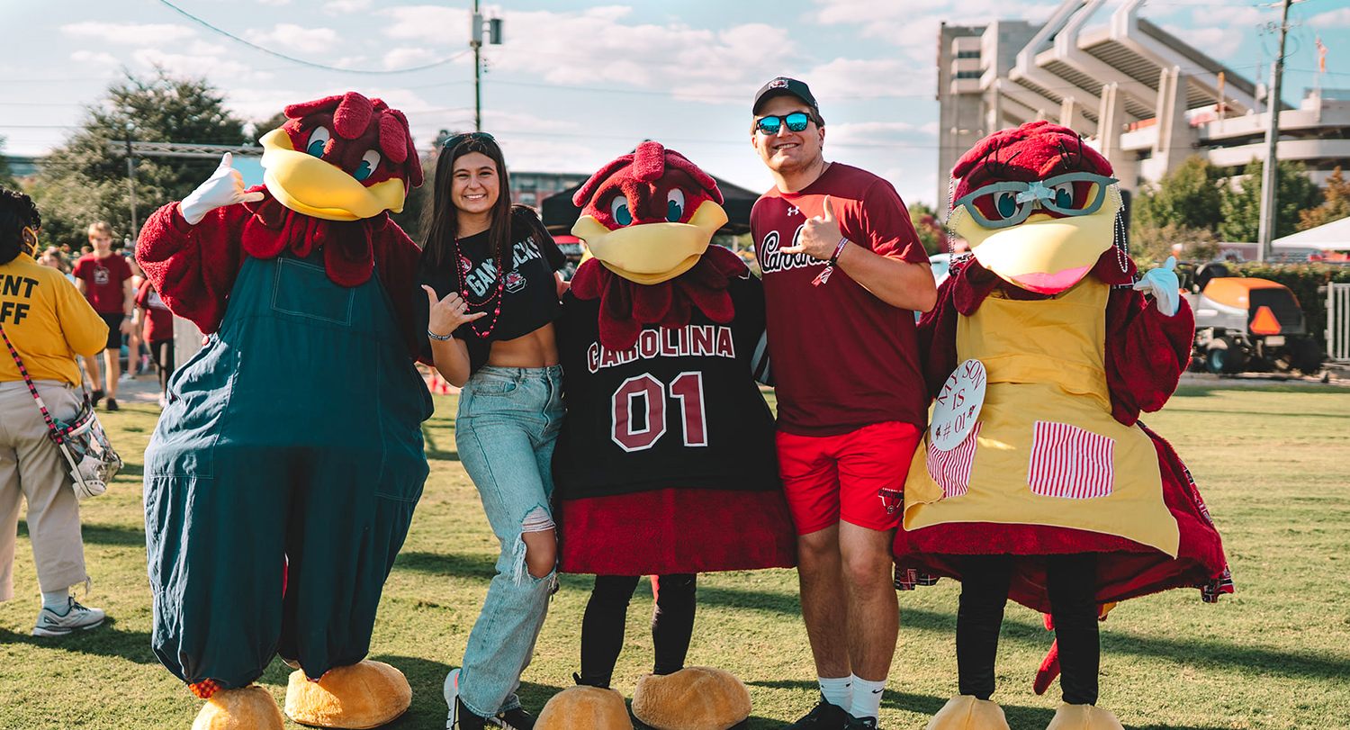 Students and their family with Cocky and his patents at the Family Weekend Tailgate. 