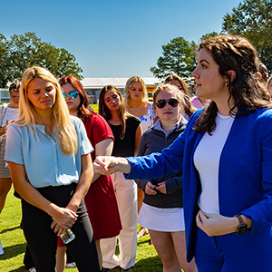 Students outside talking with a guest speaker on a field trip.