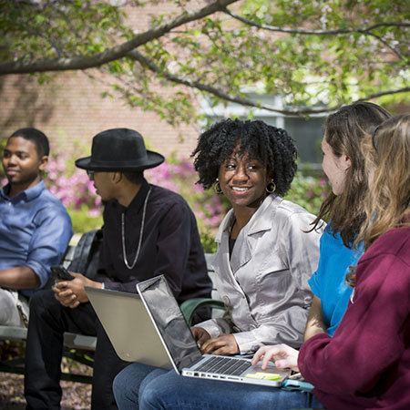 Students smiling with laptop