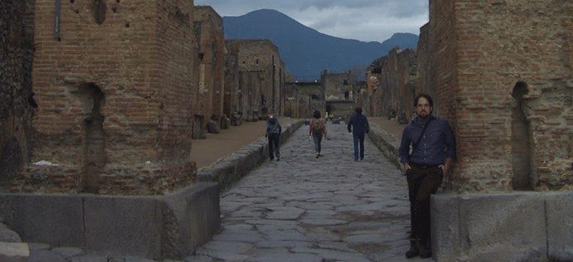 Student in front of ancient ruins