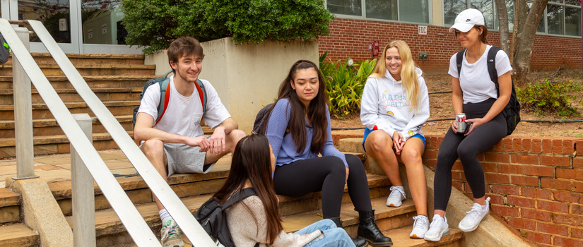 Students hanging out on steps chatting