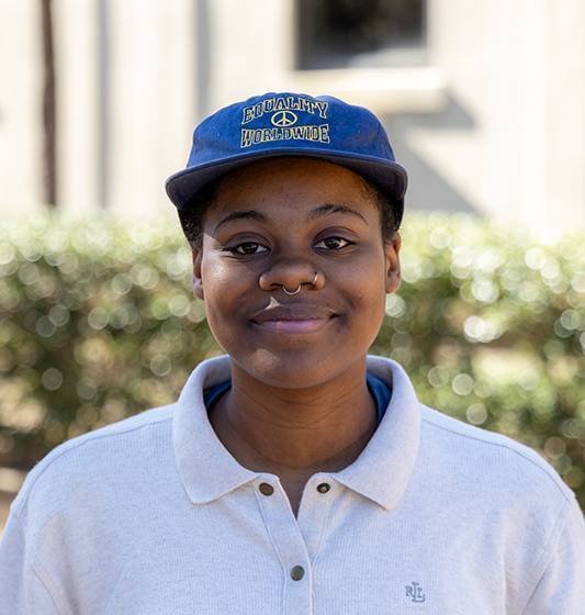 photo of a person in blue hat and gray shirt