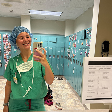 woman in scrubs taking a selfie