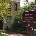 Pettigru stands near a sign for the Dean's Office