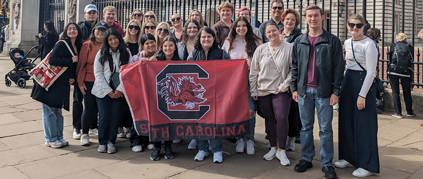 Students in the UK holding a Gamecock Flag