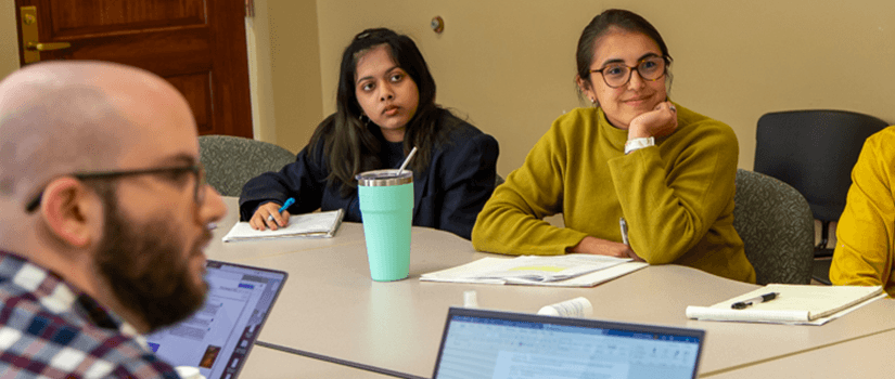 Students smiling in a class interested in the subject matter. 