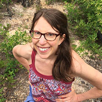 photo of woman with dark  hair and glasses smiling