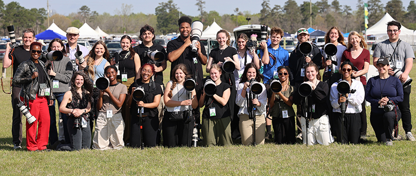 students holding camera equipment