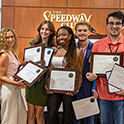 students holding awards