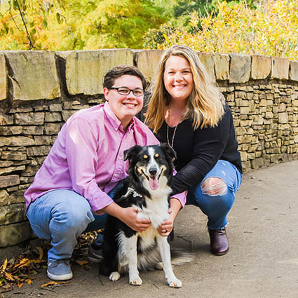 two people with a dog