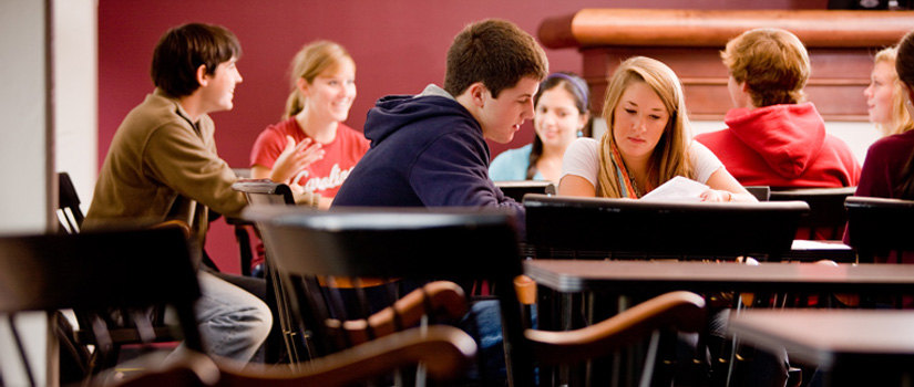 students seated and working at large tables