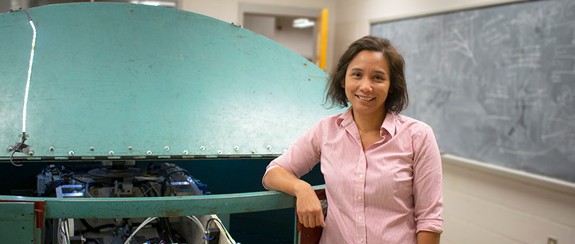 Inthourn Sasanakul stands in front of centrifuge.