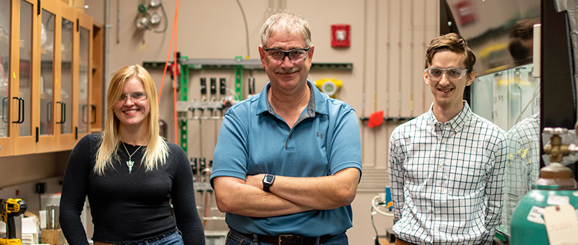 Lauterbach stands with his doctoral students.