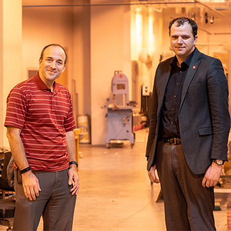 Jason Bakos and Austin Downey stand in their lab.