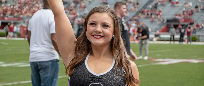 Delnoce cheering for the Carolina Girls Dance Team.