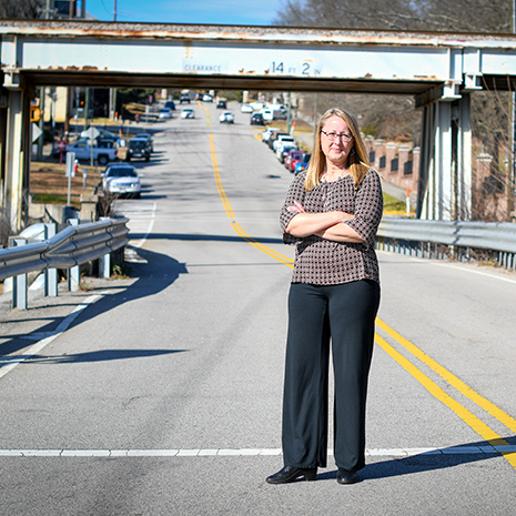 Dr. Gassman stands in a crosswalk near campus