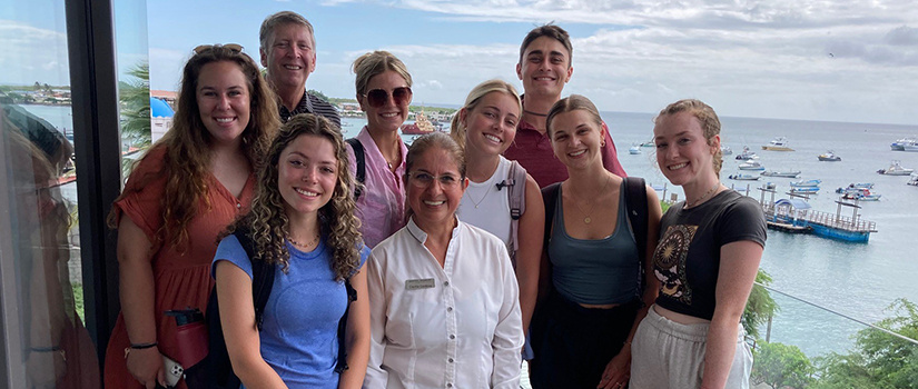 Students and faculty pose for a photo at a hotel while visiting the Galapagos Islands.