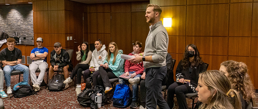 Assistant professor Scott Taylor, Jr., speaks to a group of students in the class HRSM 301 during a segment on emotional intelligence.