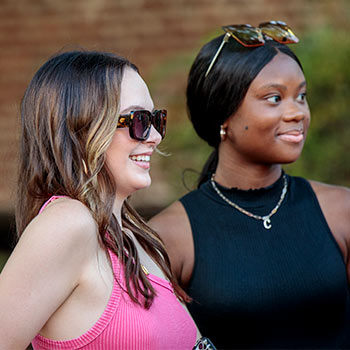 Two students hanging out at an event on Greene Street.