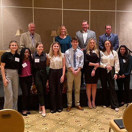 Members of the Club Management Association of America pose for a photo with staff at Innisbrook Resort & Golf Club in Palm Harbor, Florida, after touring the facility.