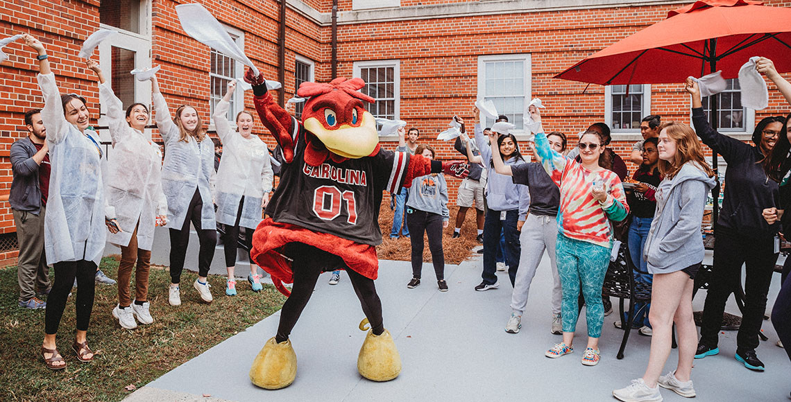 USC mascot Cocky and a group of students.