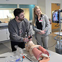 Students practicing on a mannequin. 