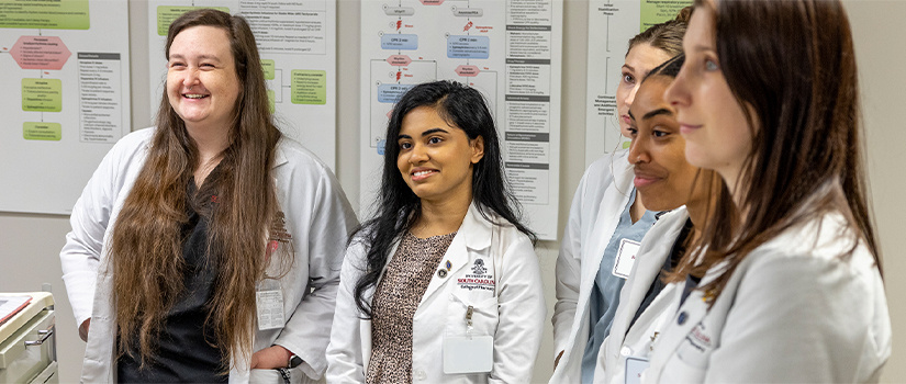 Pharmacy students with faculty member