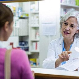 Pharmacist talking to a customer