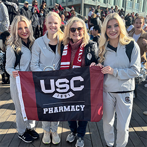 COP students and faculty holding flag