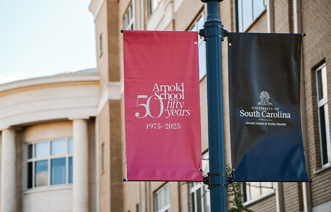 50th anniversary banners hanging on a light pole outside a building