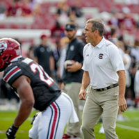 Coach Shane Beamer on football field.