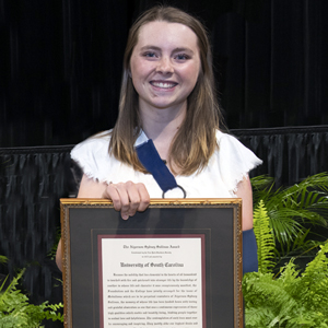 Claire Windsor poses with her framed Algernon Sydney Sullivan award