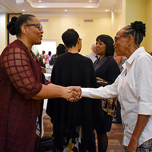 Two women shaking hands