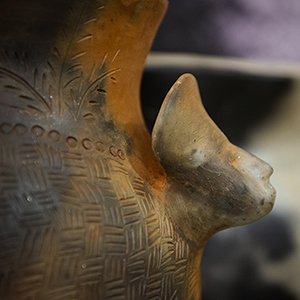 Close-up image of a piece of Catawba pottery with a Native American chief's head on the side