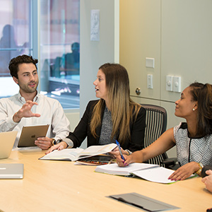 Three students collaborate at Moore School.