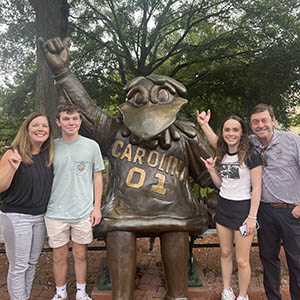 Amy and her family pose with a statue of USC's mascot, Cocky