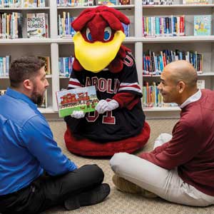 Cocky reads with (left) Jamie Ballentine and Tommy Preston