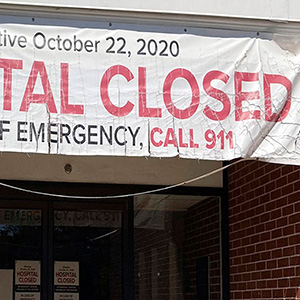 A banner hangs outside a building with the message 