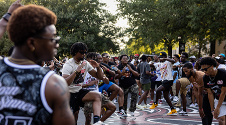 A group of young men strolling on Greene Street