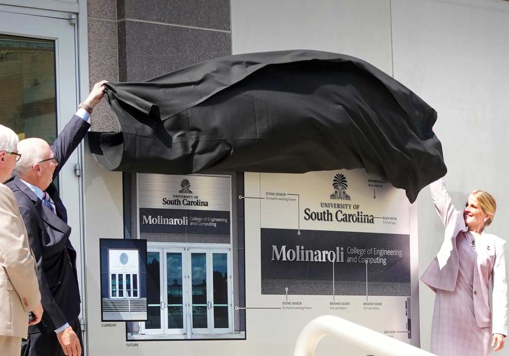 President Amiridis, Alex Molinaroli and his wife unveil the plan for new signage at the College of Engineering and Computing.