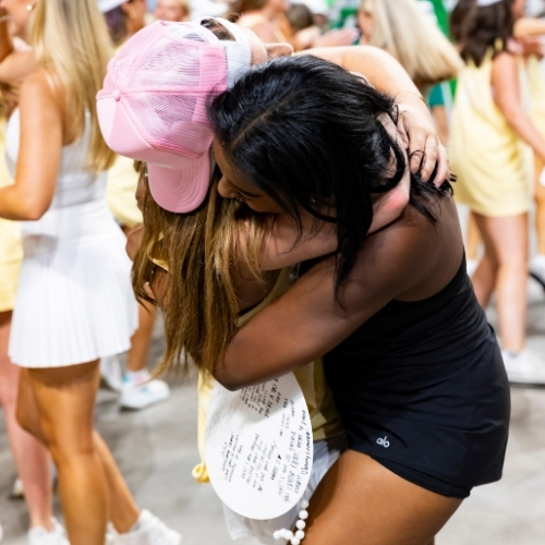 Two women hug tightly on Bid Day at USC in 2025. 