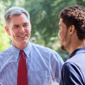 Dean Reichert speaks to a student.